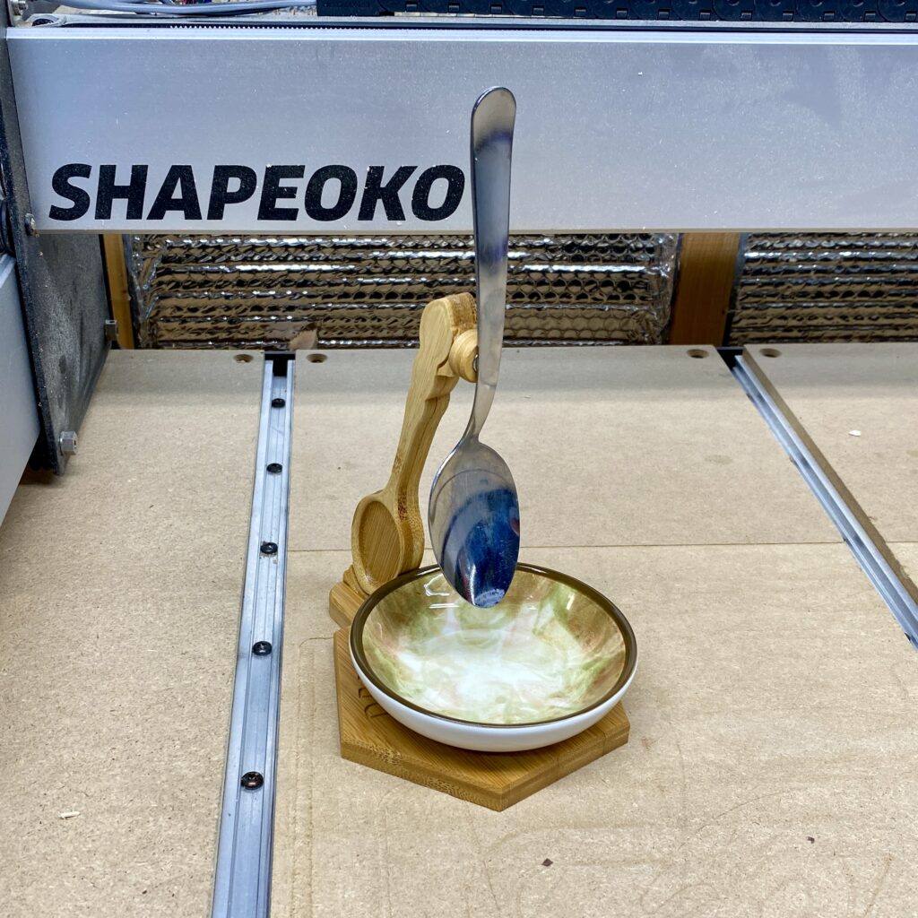 Spoon Swing with cup and spoon.
