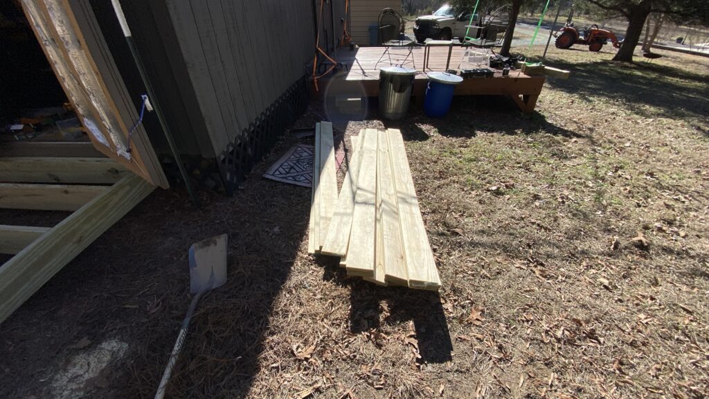 Stack of deck boards are sitting in front of the main deck and are ready to use.